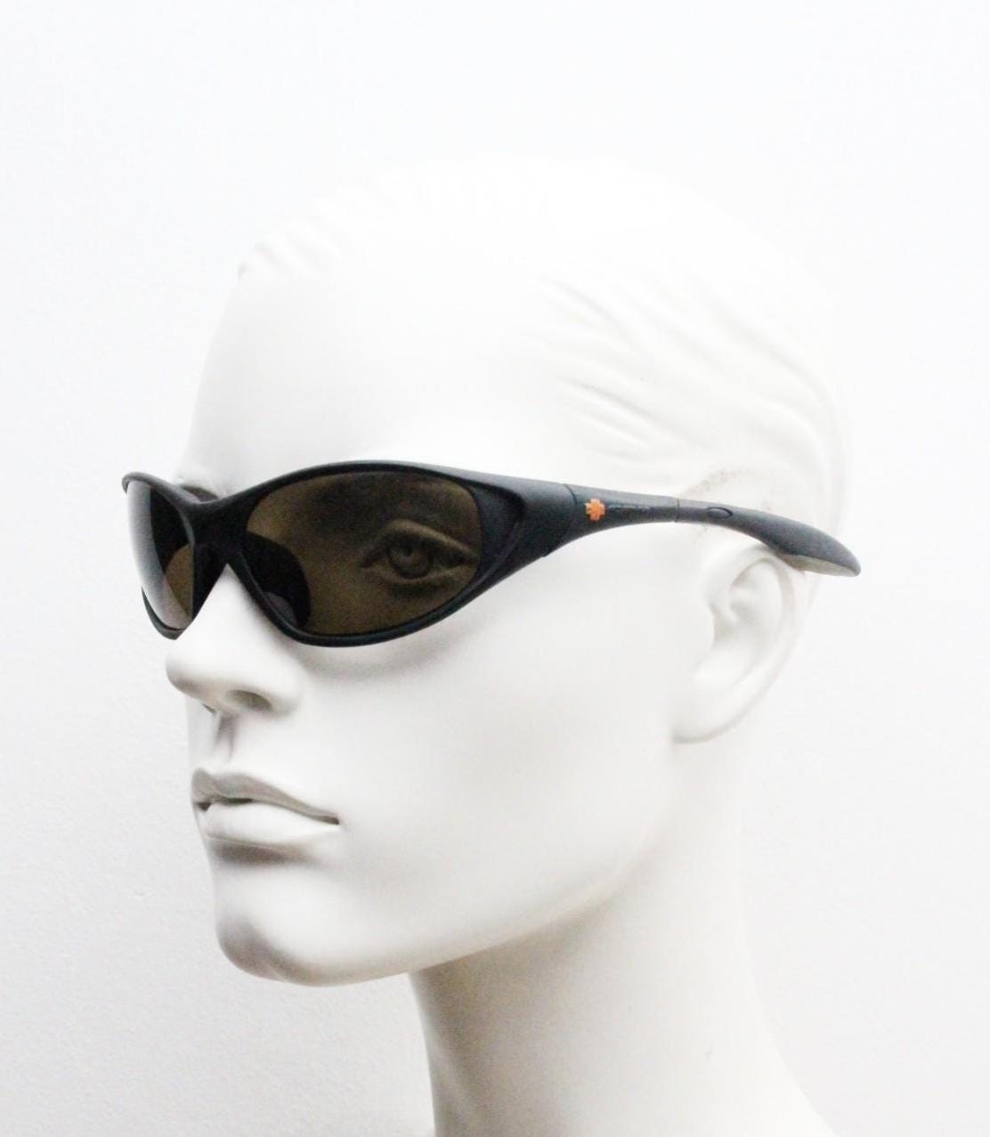 Y2K vintage sport shield aerodynamic sunglasses. All black rubber finish wraparound bug eye visor with brown lenses. 2000's. 90s