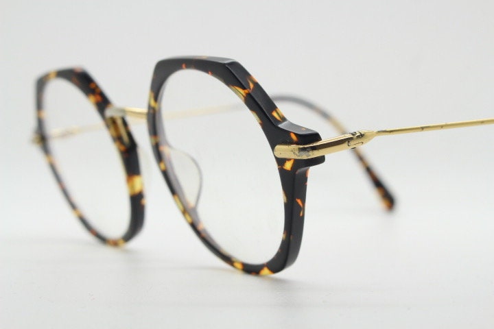 Kaleos hexagon eye glasses model Trevethyn made in Italy. Amber tortoise acetate optical frames with gold arms. Prescription eyeglasses. RX