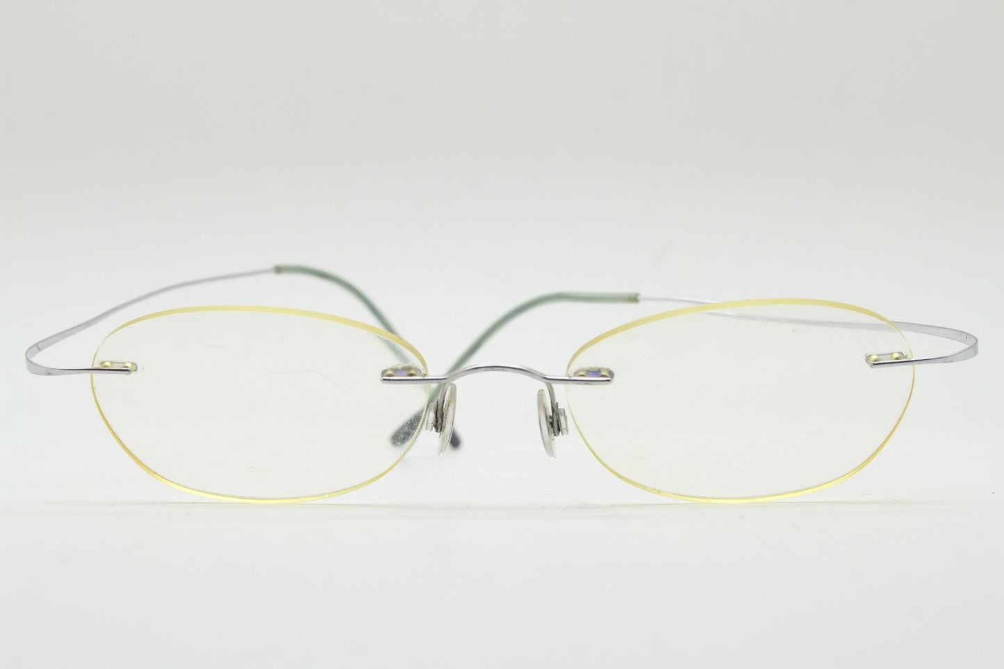 Silhouette frameless oval eye glasses. Extremely minimal lightweight titanium optical frame with springy hingeless arms. 2000s Vintage