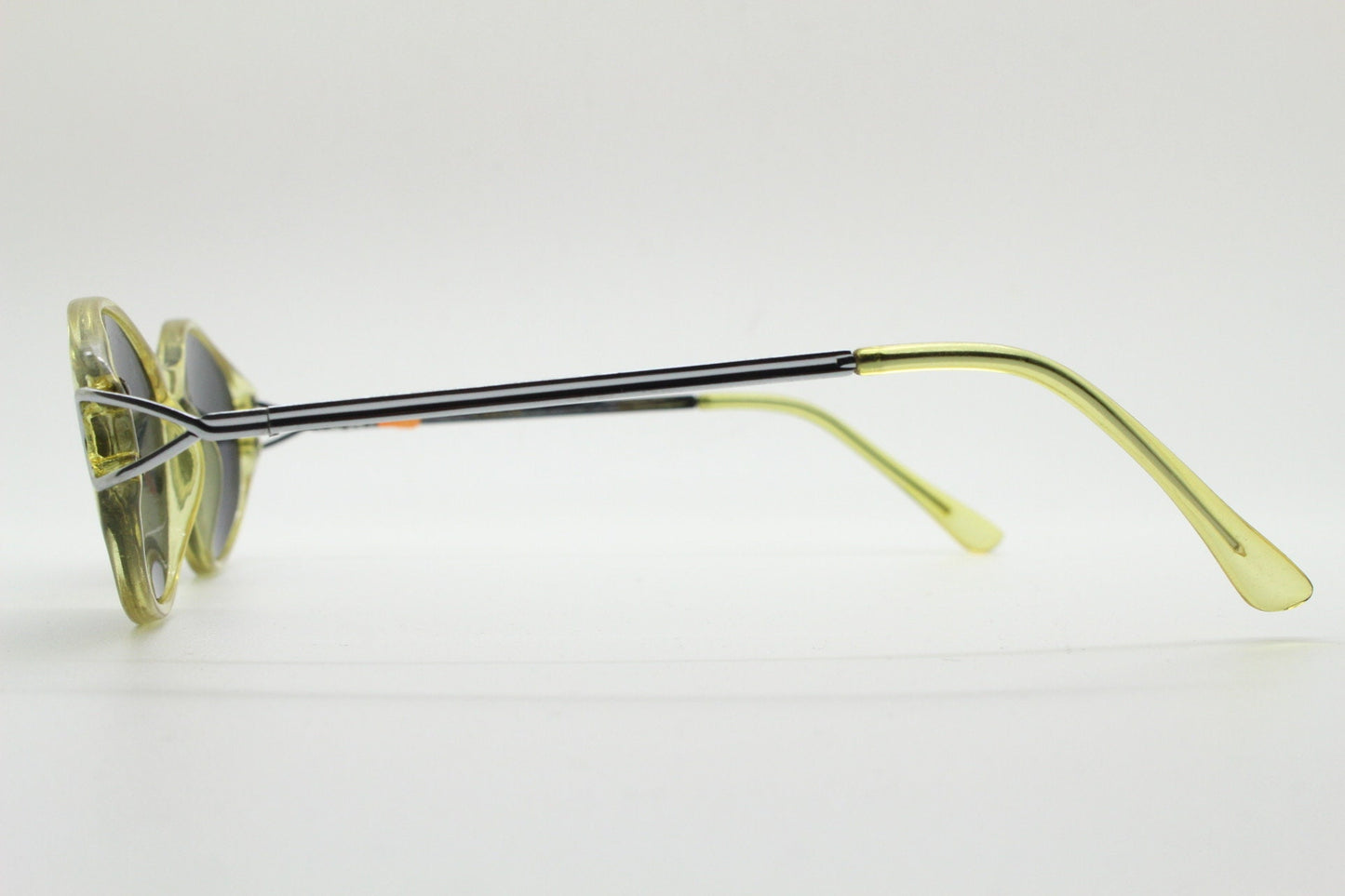 Carven Paris 90s vintage oval sunglasses. Womens transparent yellow frame with black lenses and silver metal arms. NOS