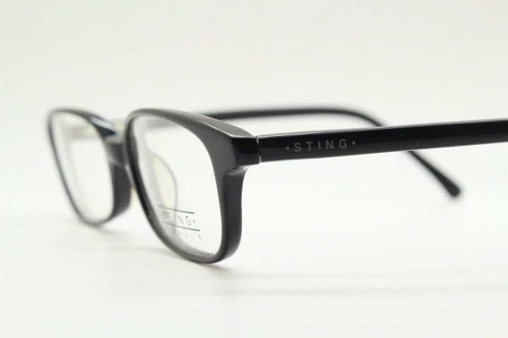 Sting 90s vintage rectangular eye glasses made in Italy. Plain black gloss low profile acetate optical frames. Prescription RX. NOS