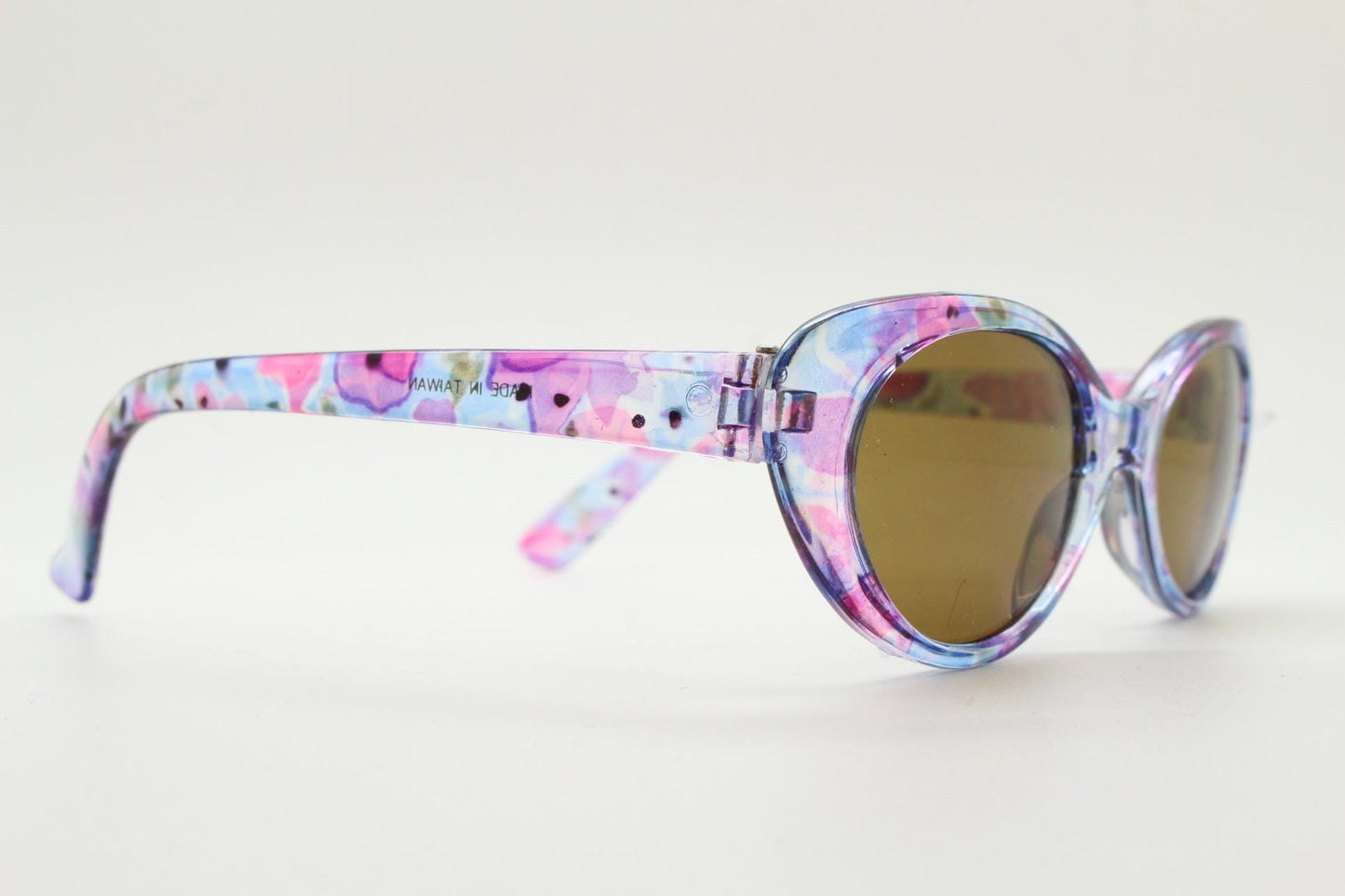 90s vintage oval cat eye sunglasses. Vibrant transparent multi coloured frame with mid tone brown lenses. 80s. NOS. BNWT