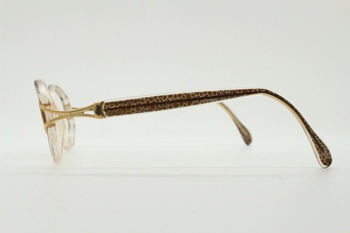 Silhouette 80s vintage oval eye glasses made in Austria. Transparent crystal optical frame with giraffe arm print. Prescription RX