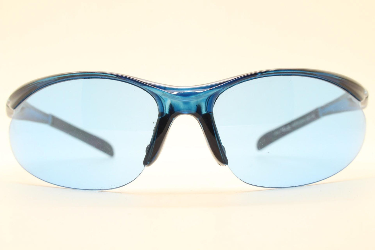 Y2K vintage sport shield sunglasses. Transparent blue frame wraparound aerodynamic visor with matching lenses. 2000's. 90s