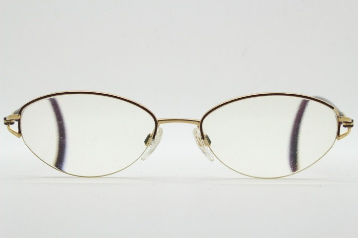 Silhouette oval half frame eye glasses model 6566 made in Austria. Minimal optical frame with gold trim deep purple arms. Prescription RX