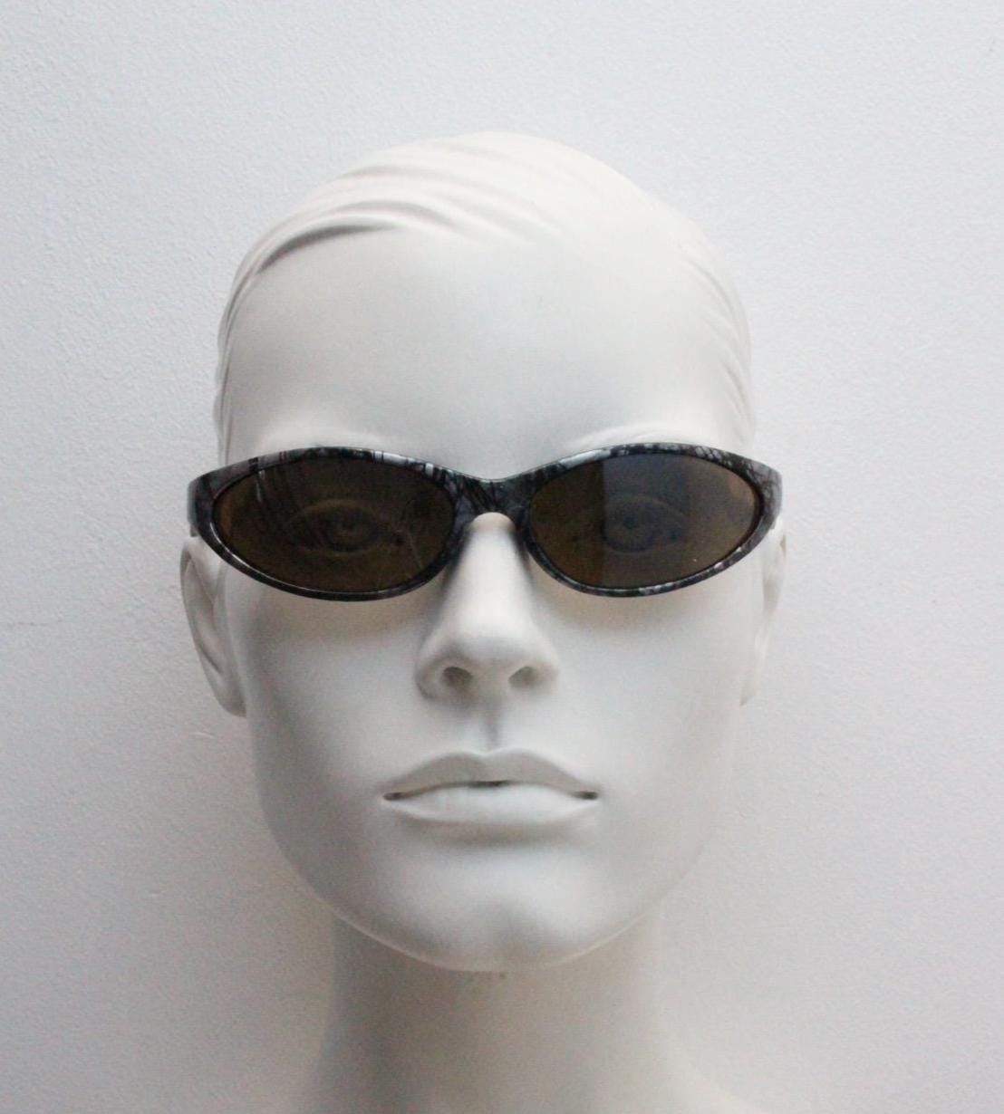 90s vintage sport shield aerodynamic sunglasses. Silver and black marble print wraparound bug eye visor with brown lenses. 2000's. Y2K