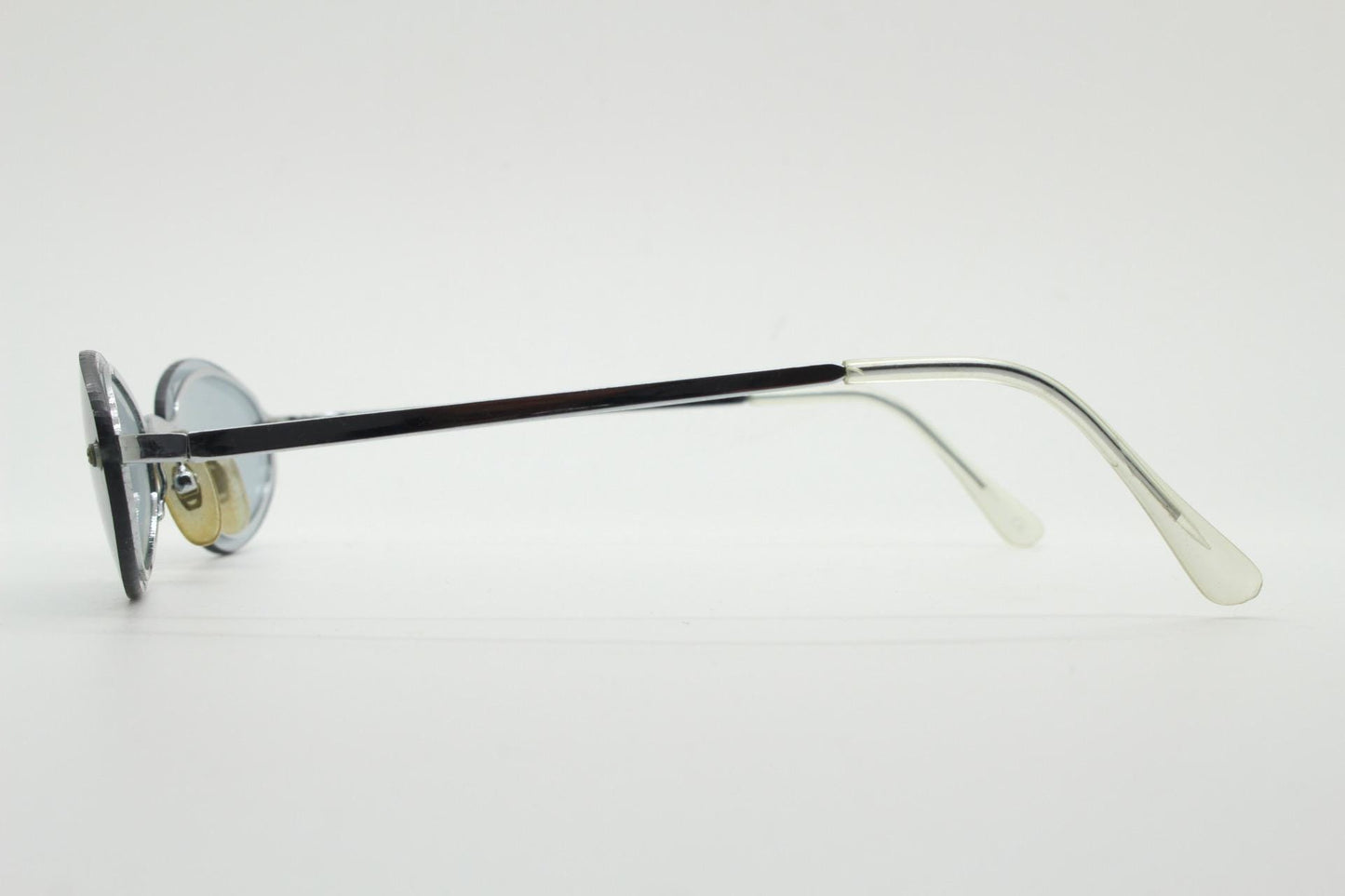 90s vintage small oval sunglasses. Minimal silver chrome metal frame with overlapping light tone grey lenses. Micro. Steampunk