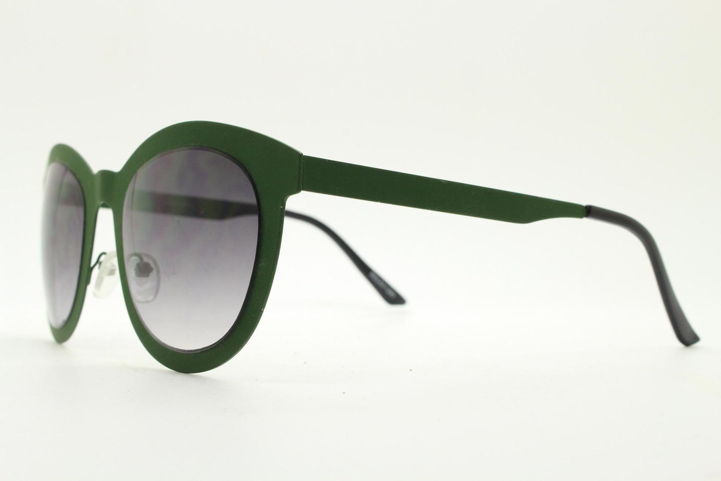 Round vintage cat eye sunglasses. Green flat metal frame in a slightly rubber finish that encases the lenses. Womens 2000s modified cateye