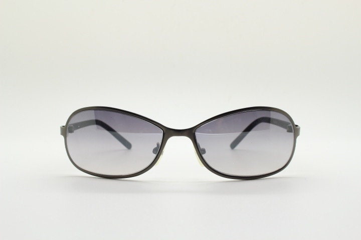 Y2K vintage mini bug eye sunglasses. Curved gunmetal grey flat metal frame with black matt arms and graduating lenses. Unused 2000s NOS