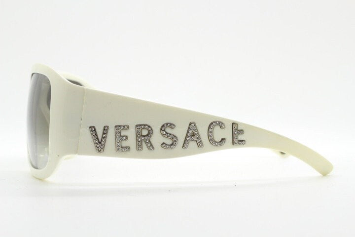 Versace Y2k vintage wrap around bug eye sunglasses. Curving white acetate shield frame with huge spell out diamante logo. 2000s. Rhinestone
