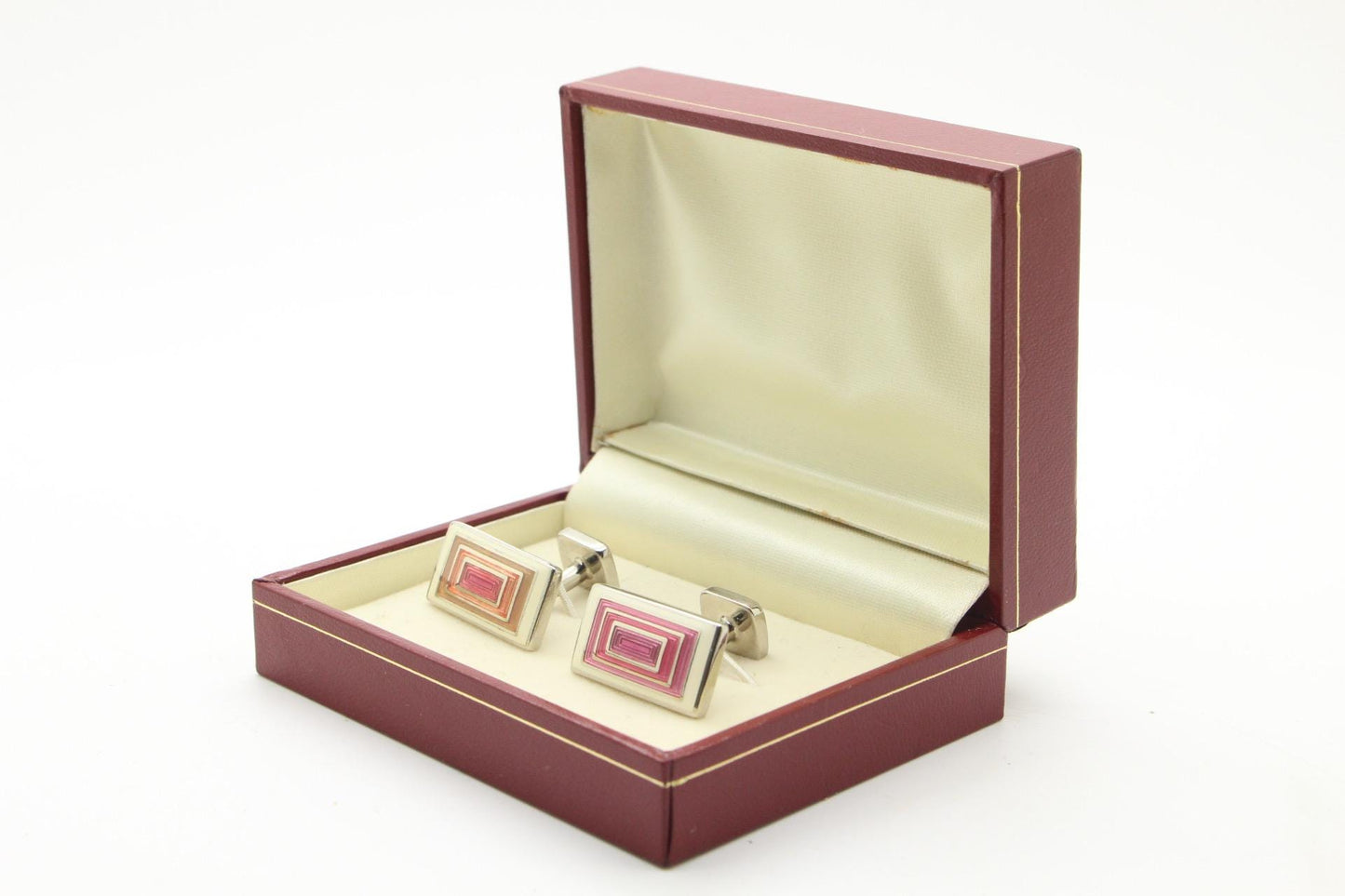 Vintage rectangular cuff links made in England by Herringbone. Solid metal construction with fine enamelled white, pink and peach tones. NOS
