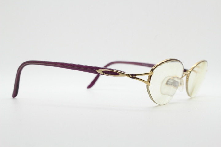 Silhouette oval half frame eye glasses model 6566 made in Austria. Minimal optical frame with gold trim deep purple arms. Prescription RX