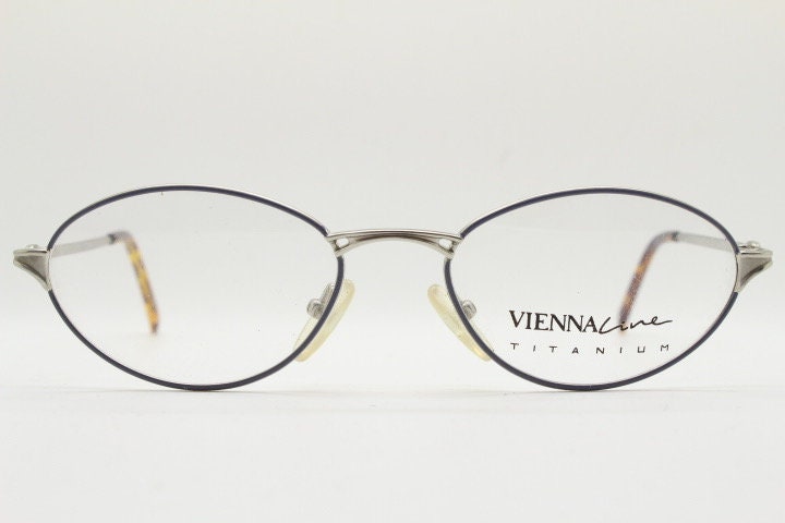 Viennaline 90s vintage oval eye glasses made in italy from titanium. Satin silver optical frame with grey enamel outline. Prescription RX