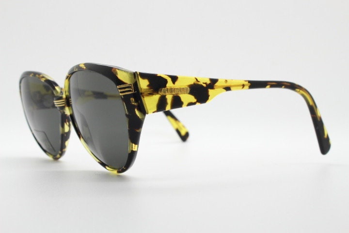 Gucci 90s vintage large oval sunglasses model 2135 made in Italy. Vibrant amber and mottled brown bug eye. NOS