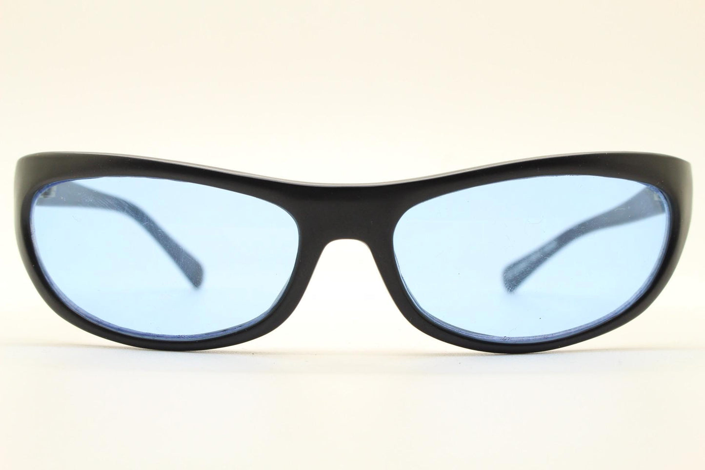 90s vintage curved wraparound sunglasses. Aerodynamic low profile black satin finish frame with light tone blue lenses. Sports shield. NOS