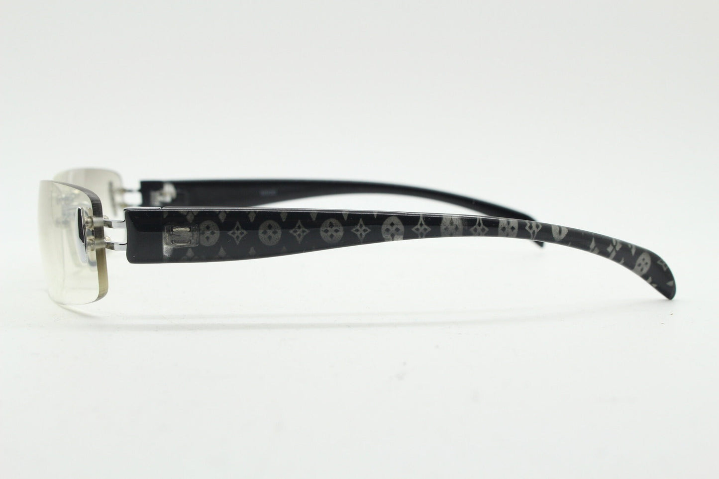 Y2K vintage frameless sunglasses. Silver chrome trim with patterned arms and extra light tone graduated curved mirror lenses. 2000's. 90s