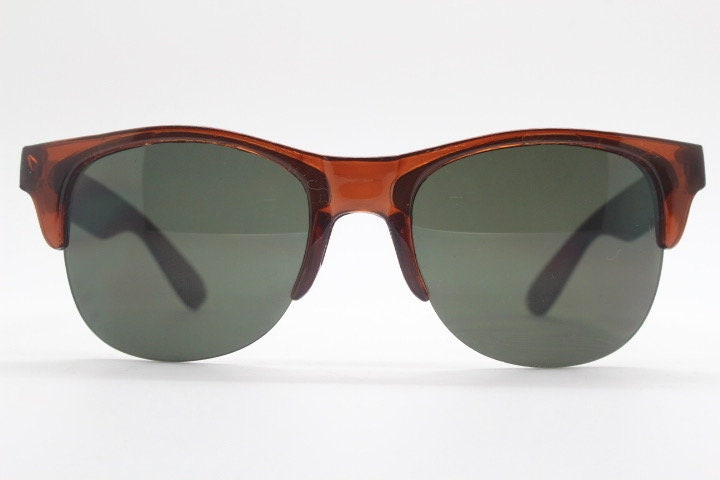 90s vintage modified wayfarer design sunglasses. Transparent brown browline half frame with brown or green interchangeable lenses . NOS