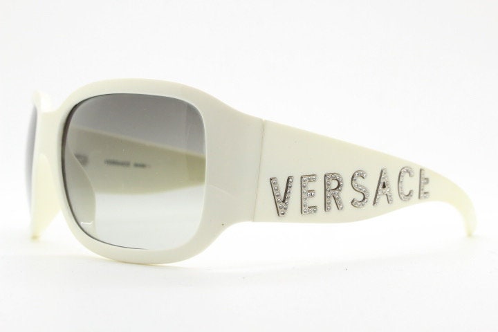 Versace Y2k vintage wrap around bug eye sunglasses. Curving white acetate shield frame with huge spell out diamante logo. 2000s. Rhinestone