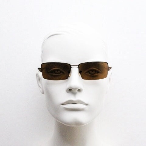 Y2K vintage curved rectangular sunglasses. Minimal half frame in brown chrome with mid tone lenses and straight arms. 2000's. 00's NOS