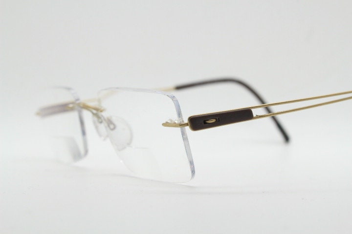 Silhouette rectangular frameless eye glasses model 7677 made in Austria. Minimal lightweight optical frame with golden trim. Prescription RX