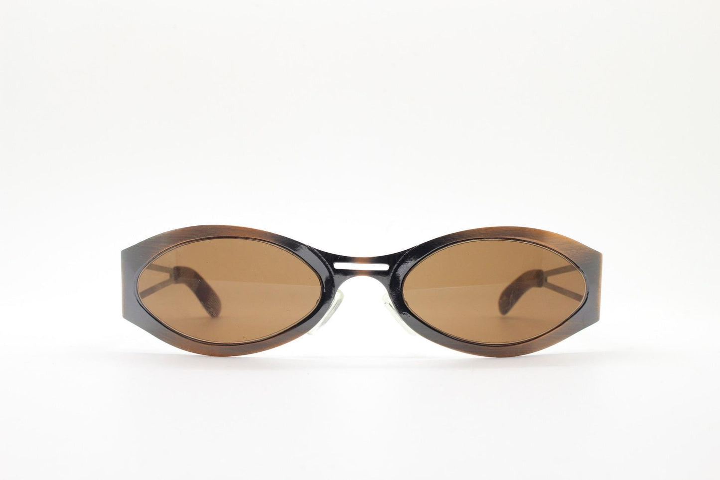 2000s vintage wraparound angular sunglasses. brushed copper finish flat curved metal frame with cut out arms. 90s. Y2K unused NOS