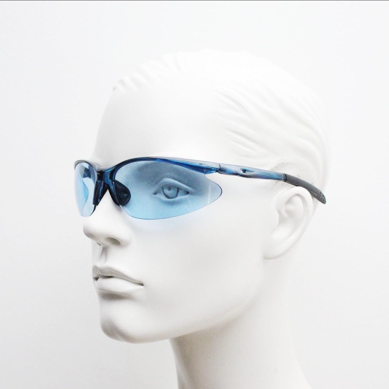 Y2K vintage sport shield sunglasses. Transparent blue frame wraparound aerodynamic visor with matching lenses. 2000's. 90s