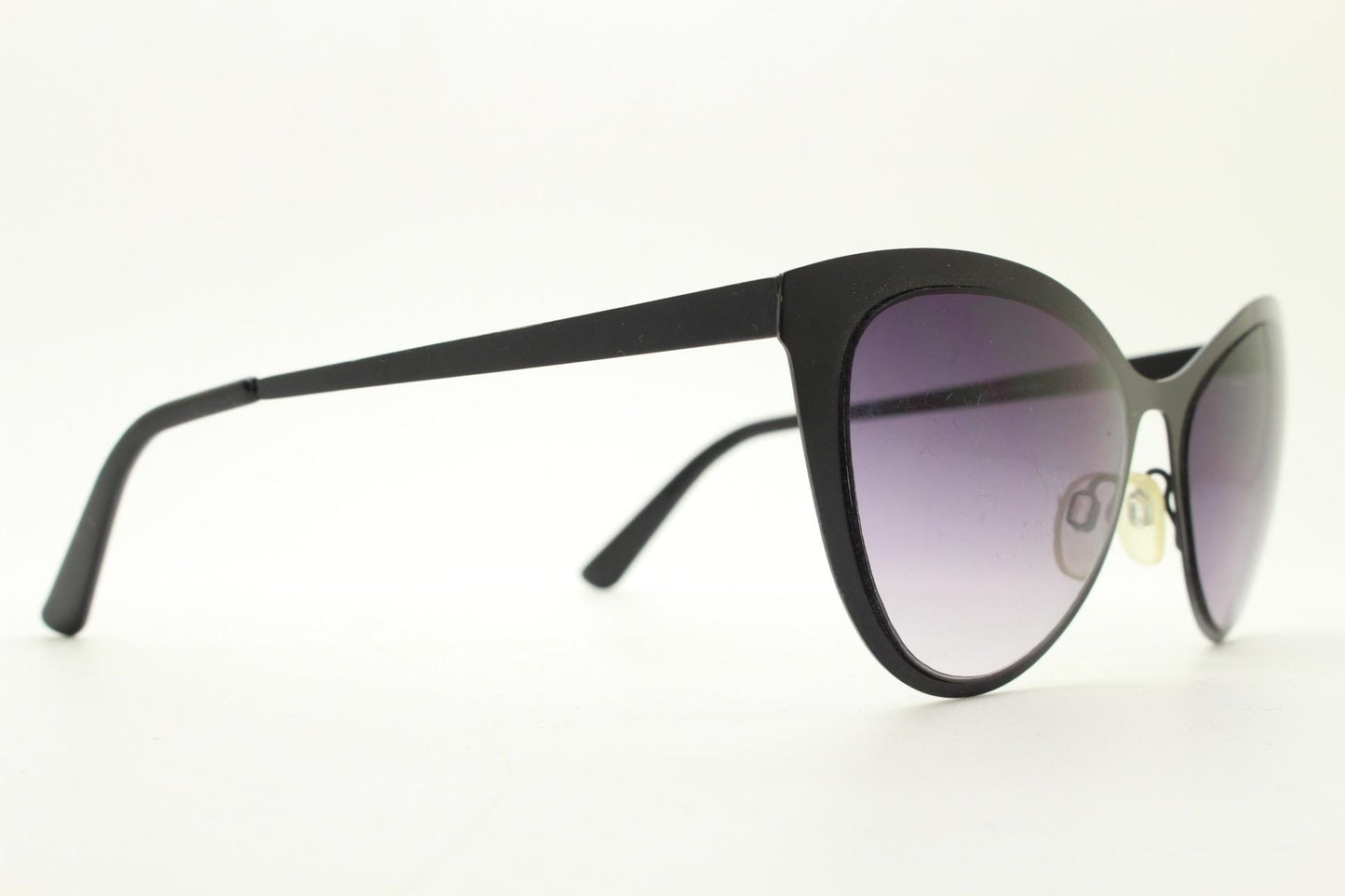 Vintage pointed cat eye sunglasses. Flat metal frame in a satin finish encasing smoky grey graduating lenses. Womens cateye