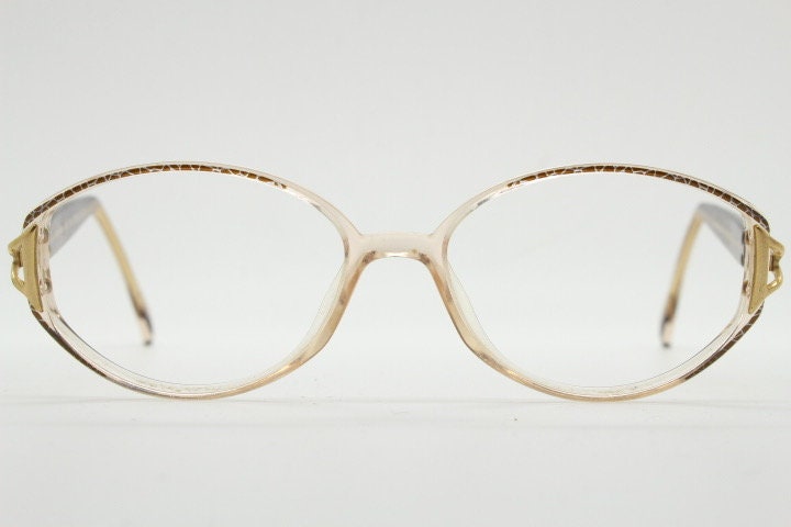Silhouette 80s vintage oval eye glasses made in Austria. Transparent crystal optical frame with giraffe arm print. Prescription RX