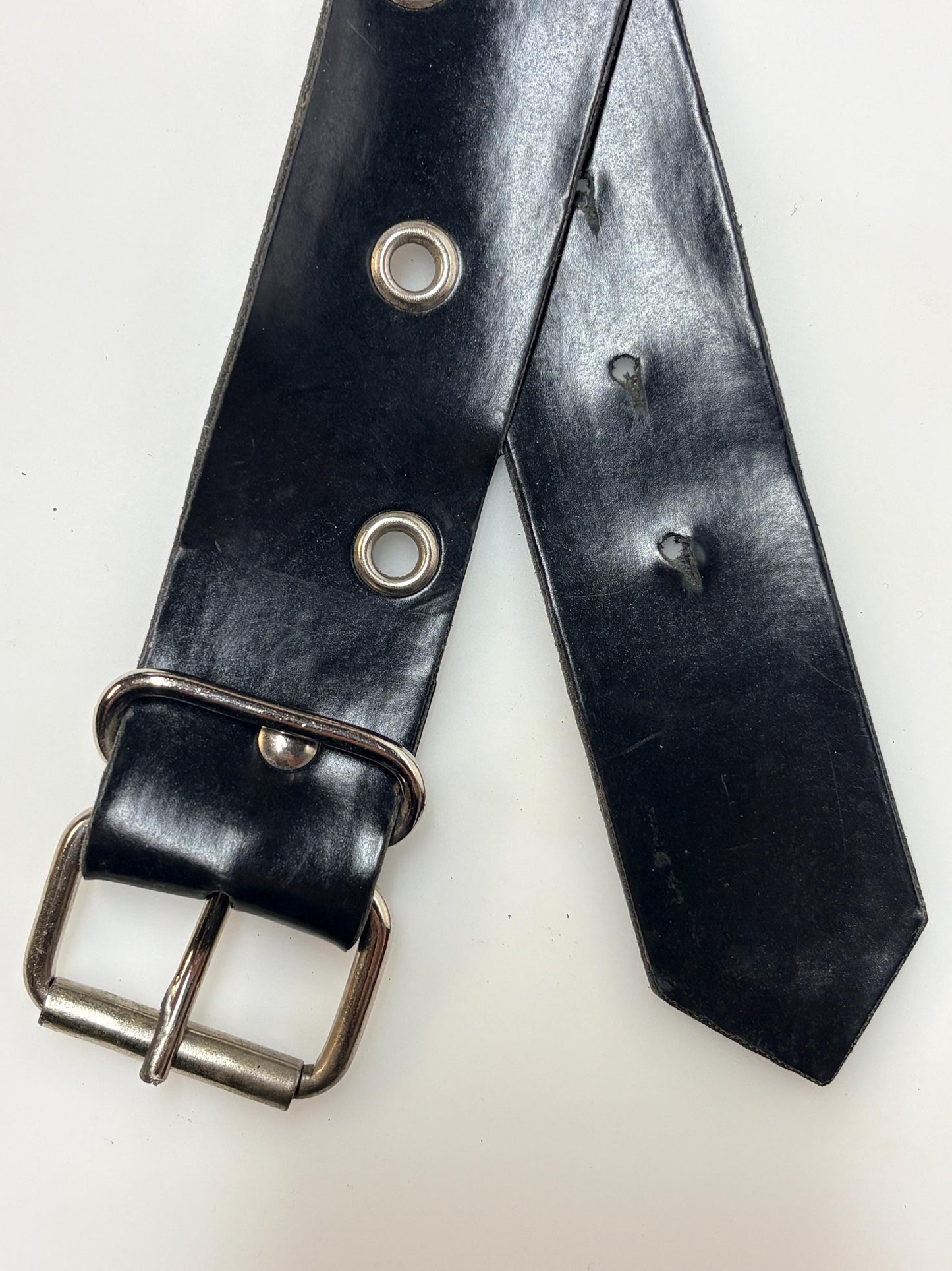 Y2k vintage womens jeans belt with silver buckle and scattered round lace holes. Thick black vinyl. Can be worn with a dress. 2000s NOS