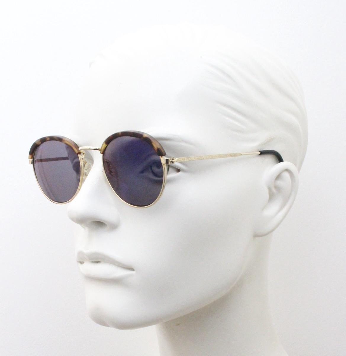 90s round vintage sunglasses. Gold frame with tortoise brows, blue mirror lenses and intricate embossed arm patterns. 1930's style