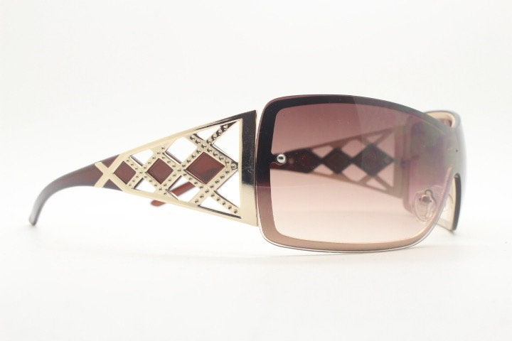 Y2K vintage visor sunglasses. 2000's brown wraparound mono lens mini mask shield design with stupendous lattice arms. Bug eye. Unworn NOS