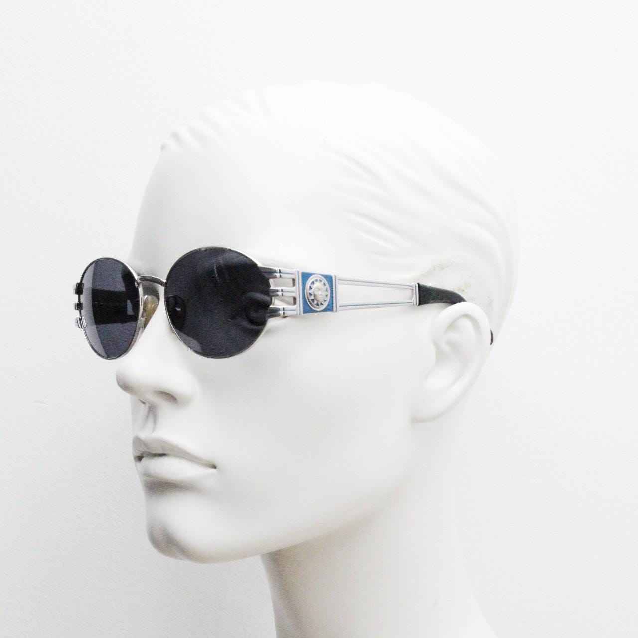 Sunsweet 90s vintage metal oval sunglasses made in Italy. Definitive ornate temple design with classical sun crests in silver chrome. NOS