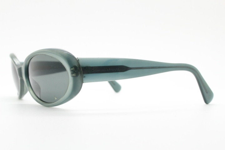 Giorgio Armani 90s vintage oval sunglasses made in Italy. Transparent grey\blue acetate frame with matching lenses. Small bug eye. Y2K