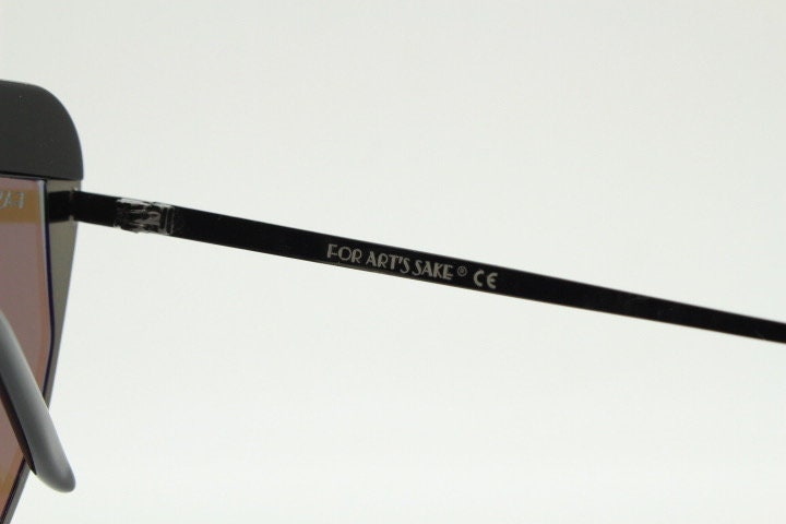 For Arts Sake angular cat eye hand made sunglasses. Black flat top 'eyebrow' design with blue mirror lenses and gunmetal grey frame