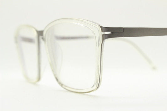 Modo rectangular eye glasses made in Japan. Matt grey titanium optical frame encasing transparent crystal acetate front. Prescription RX