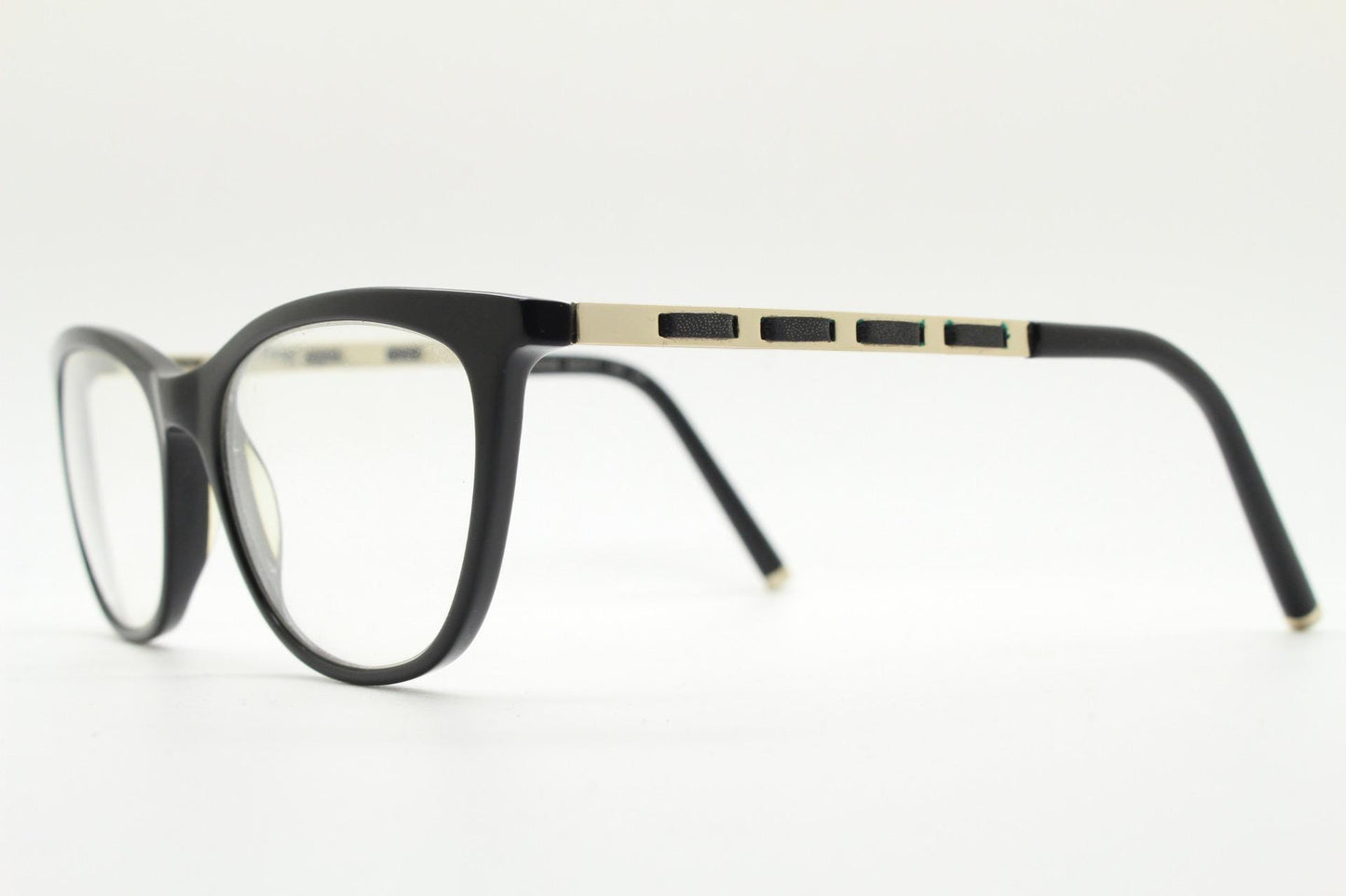 Vintage elegant cat eye glasses by Heritage. Black gloss acetate optical frames with leather lattice arms. Prescription RX cateye spectacles