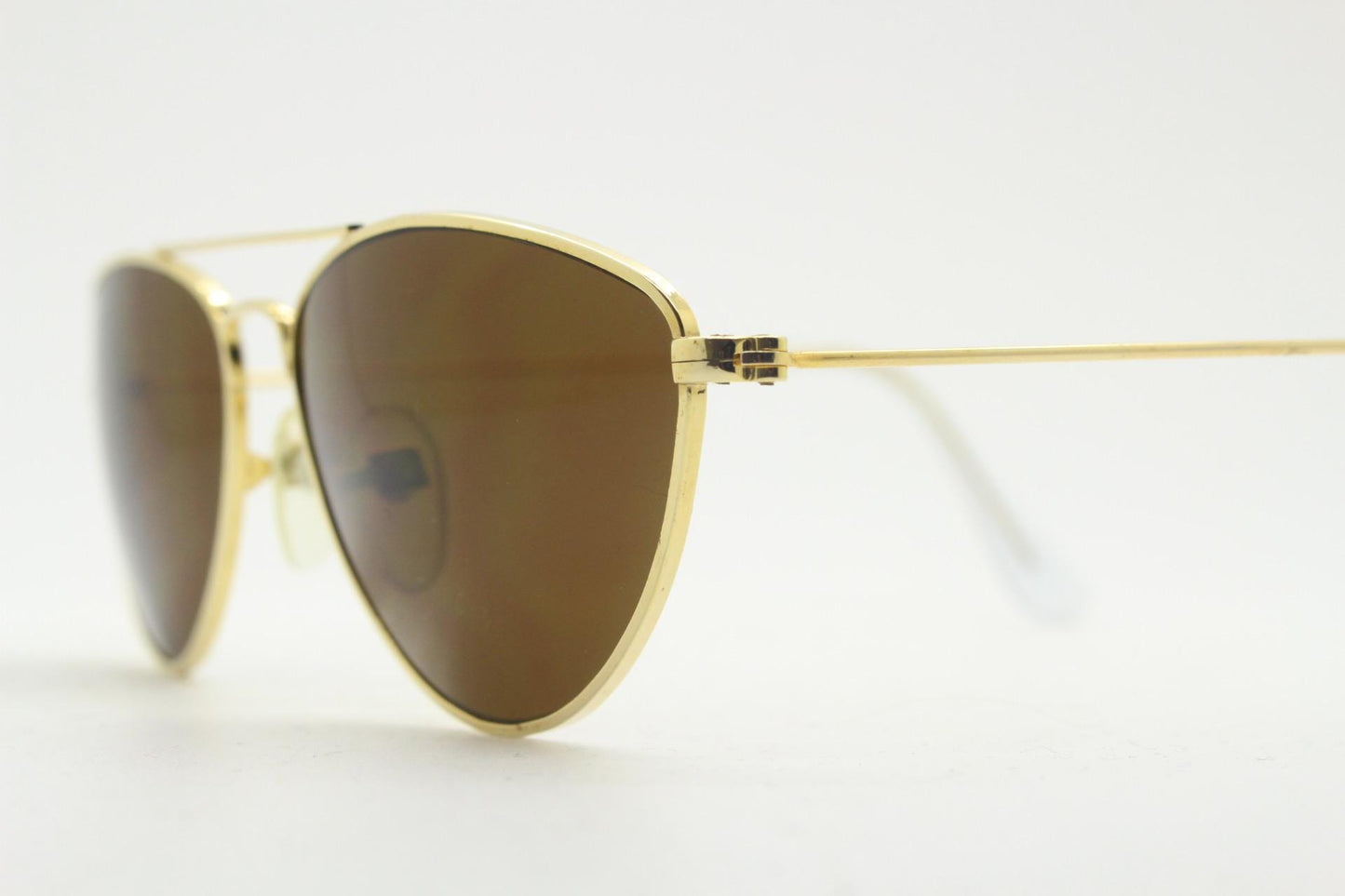 90s vintage minimal triangular sunglasses. Slim gold frame with plain brown lenses. Small modified aviator design. NOS