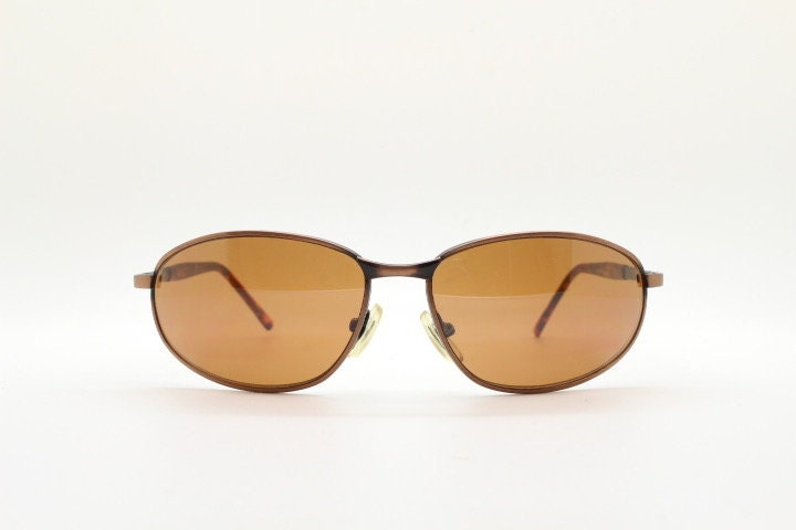 Y2K vintage small bug eye aviator sunglasses. Curved copper brushed finish solid metal frame with tortoise arms. Unused 2000s NOS
