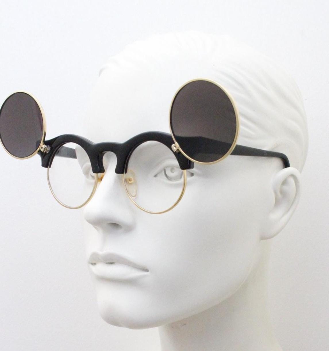 Vintage 80s round flipper sunglasses. Black gloss frame with clear lenses and incredible side flip up shades . BNWT unused NOS