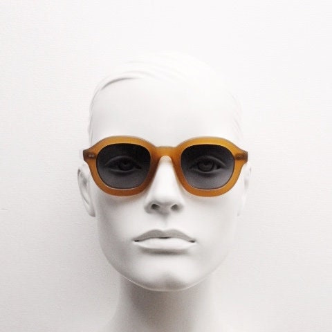 Kopajos thick framed round sunglasses. Hand made transparent amber acetate chunky frame with contrasting graduating lenses