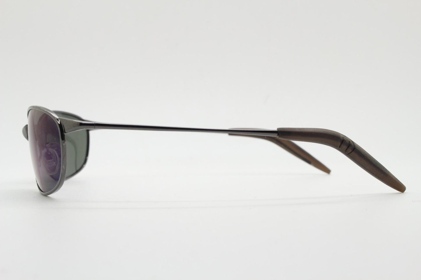 90s vintage curved oval sunglasses. Solid metal low profile frame in grey chrome with slightly mirrored dark lenses. 2000's. Y2K NOS