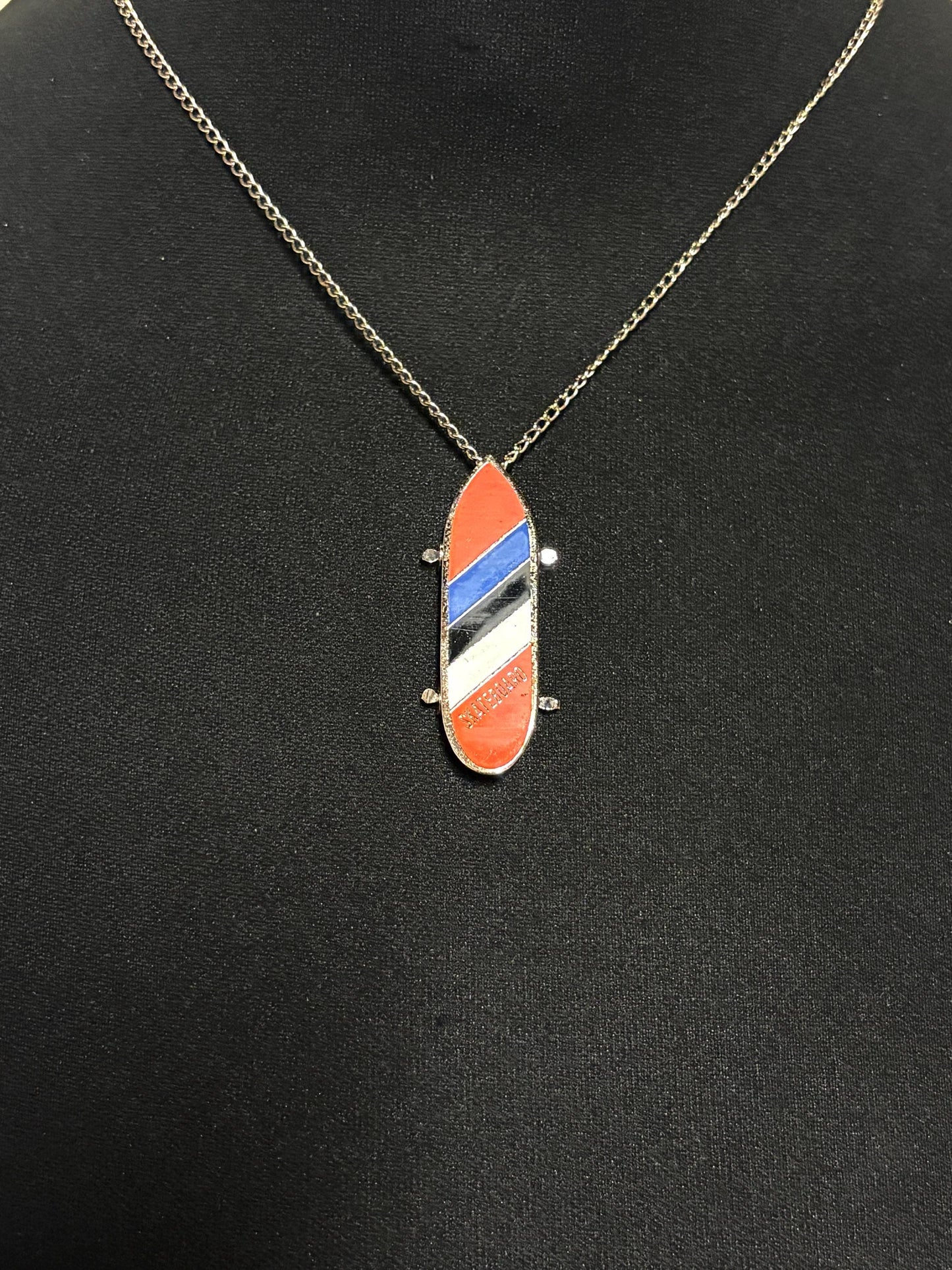 80s vintage skateboard pendant necklace. Metal chrome with enamelled red, blue and white colour stripes. Charming authentic design. NOS