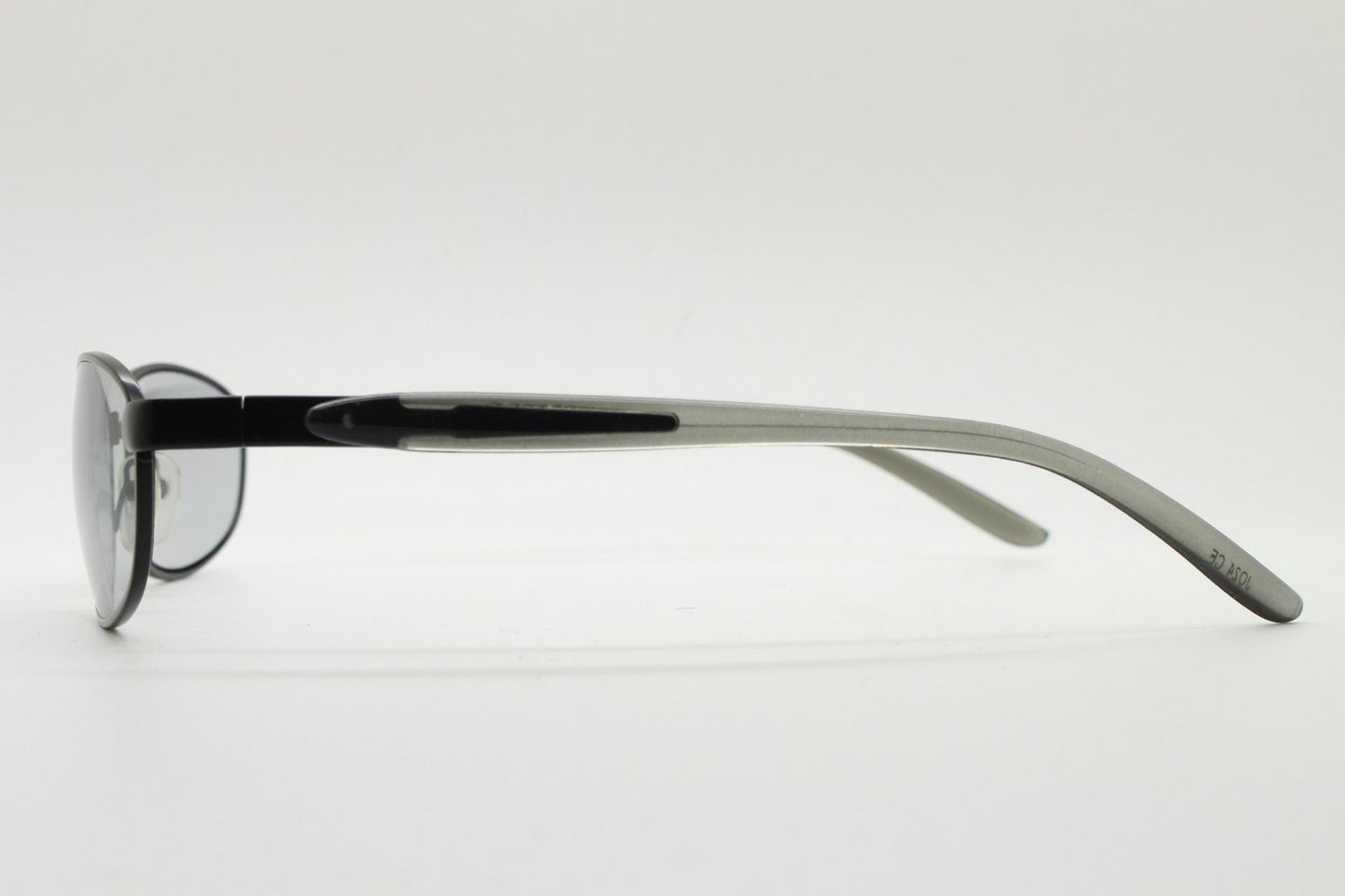 90s vintage oval small bug eye sunglasses. Curved black satin finish metal frame with transparent grey arms and light tone lenses. NOS