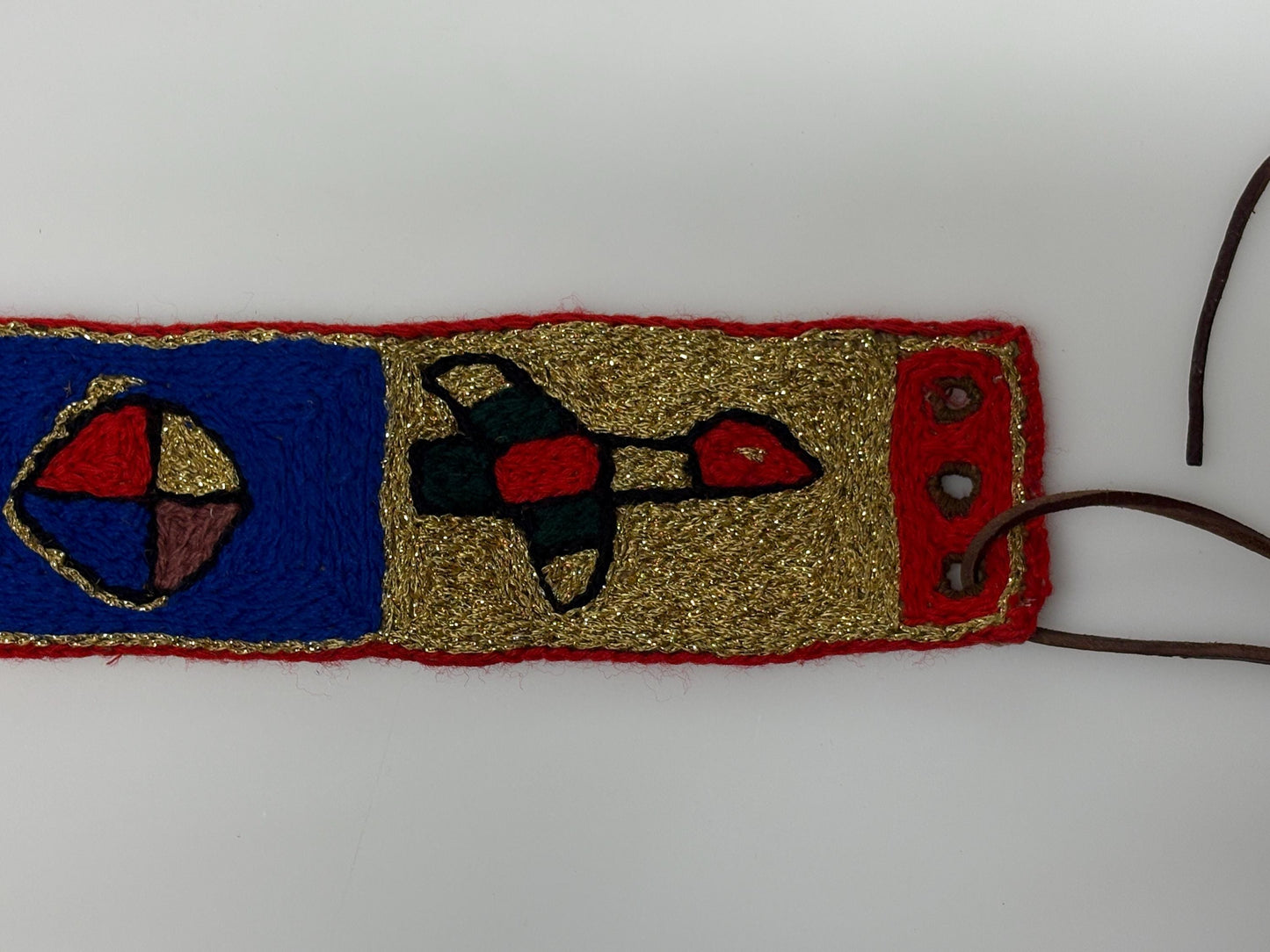 60s vintage completely hand made knitted belt. Embroidered sun, bird and abstract symbols with leather laced tie. Womens unique one off