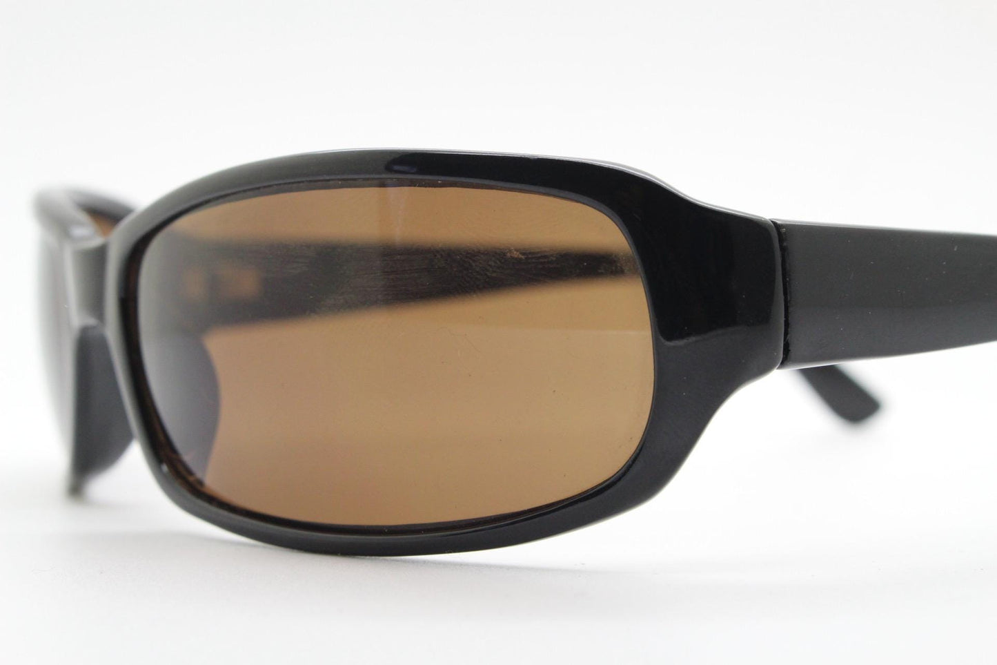 Y2k vintage wrap around rectangular sunglasses. Low profile curved black gloss frame with plain brown lenses. 2000's bug eye. NOS