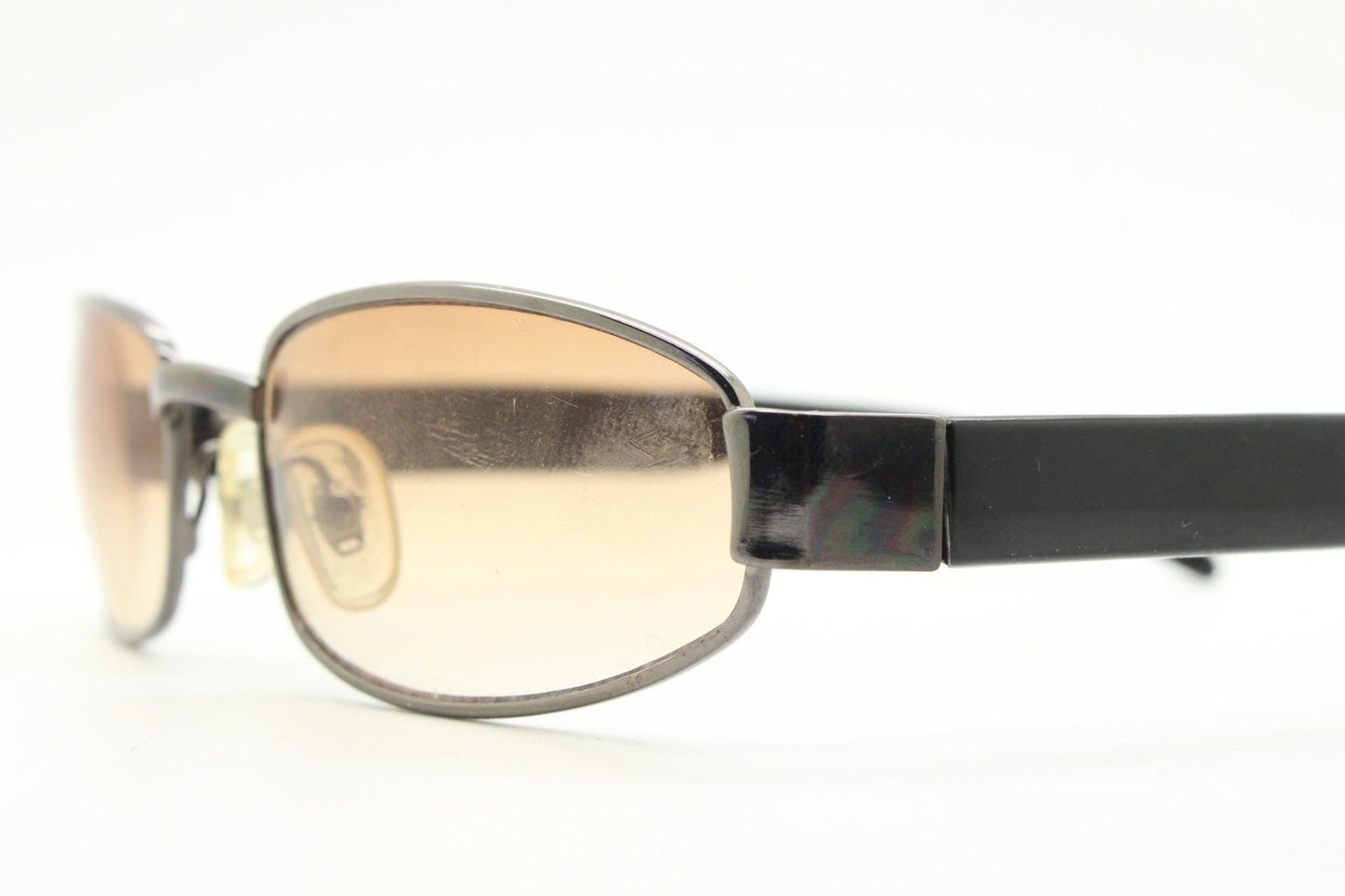 90s vintage oval sunglasses small bug eye with light tone lenses. Satin finish brown metal frame with black arms. 2000's. NOS