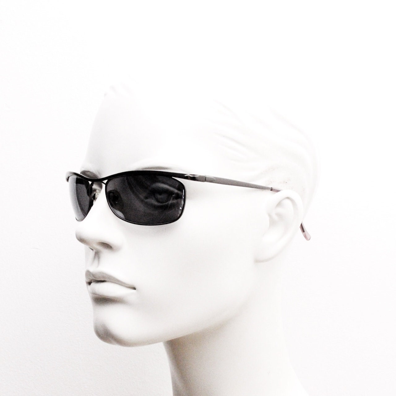 Y2K vintage curved oval sunglasses. Minimal grey chrome metal aerodynamic sport shaped frame. 2000's. 00's NOS