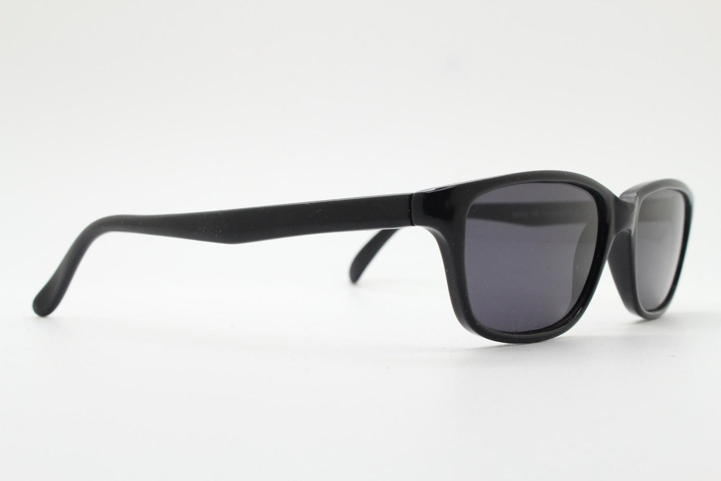 Vintage 90s slim rectangular modified wayfarer design sunglasses made in Italy. All black gloss low profile acetate frame. Unused NOS