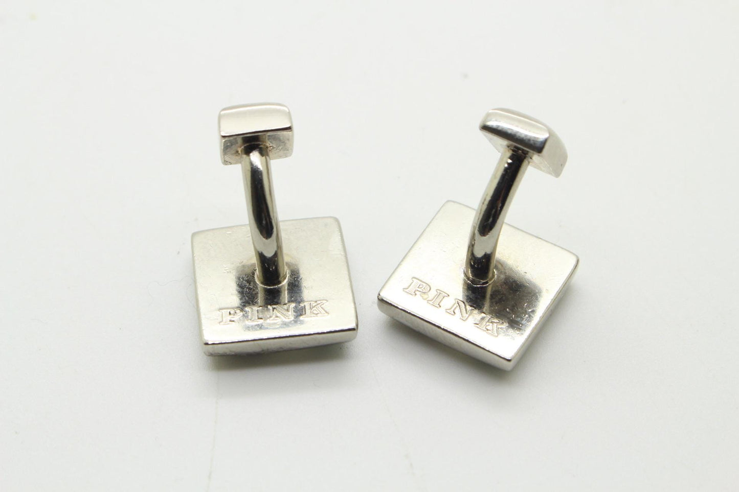 Thomas PInk vintage square cuff links made in England. Solid metal construction with enamel stripes in green and yellow tones. Unused NOS