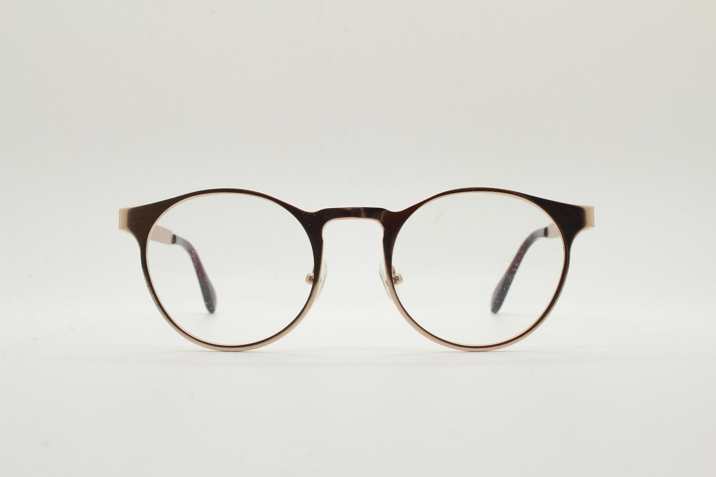 Y2K round metal eye glasses with pointed corners. Solid flat shiny golden frame with clear lenses.
